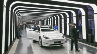 Mitarbeiter der Tesla Gigafactory Berlin Brandenburg arbeiten an der Endkontrolle der fertigen Elektrofahrzeuge vom Typ Model Y.