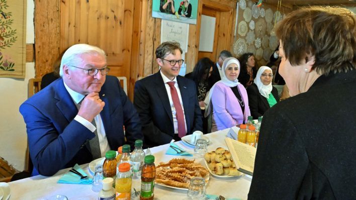 Bundespräsident Frank-Walter Steinmeier (l) und Bürgermeister Andreas Pfeifer (CDU) nehmen an einem Gespräch mit Frauen vom Verein Unsere Welt - eine Welt e.V. teil.
