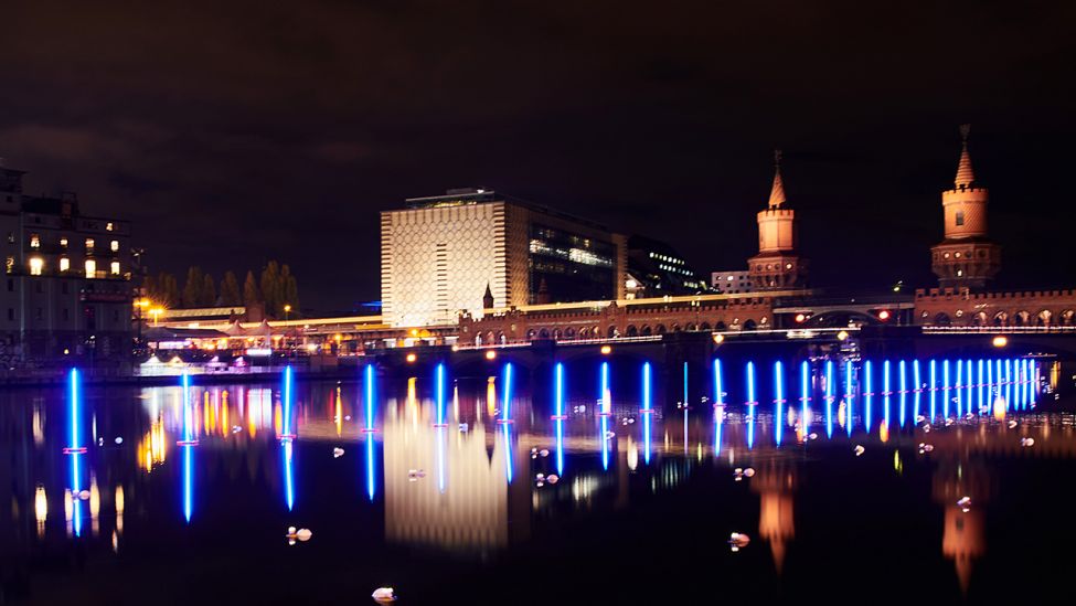 Neonblau leuchtende Stabbojen schwimmen auf der Spree an der Oberbaumbrücke (r). (Quelle: dpa/Annette Riedl)