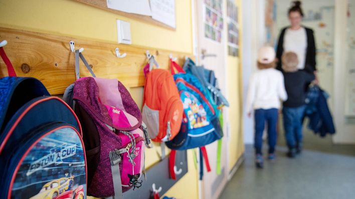 Symbolbild: Kinderrucksäcke hängen im Eingangsbereich in einem Kindergarten. (Quelle: dpa/Monika Skolimowska)