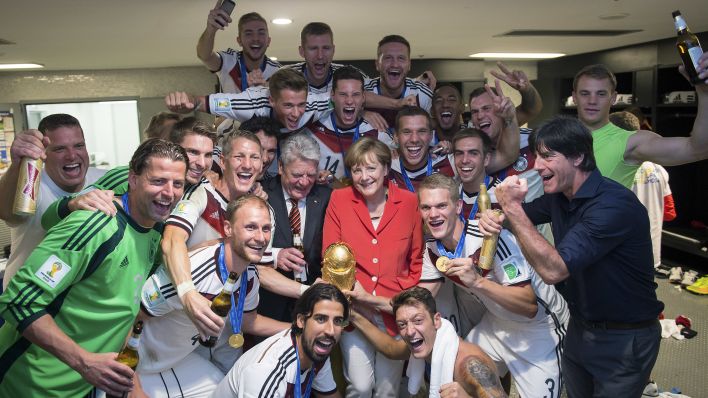 Angela Merkel und Joachim Gauck nach dem WM-Sieg der deutschen Nationalmannschaft 2014 in der Kabine (Quelle: dpa/Bundesregierung/Guido Bergmann)