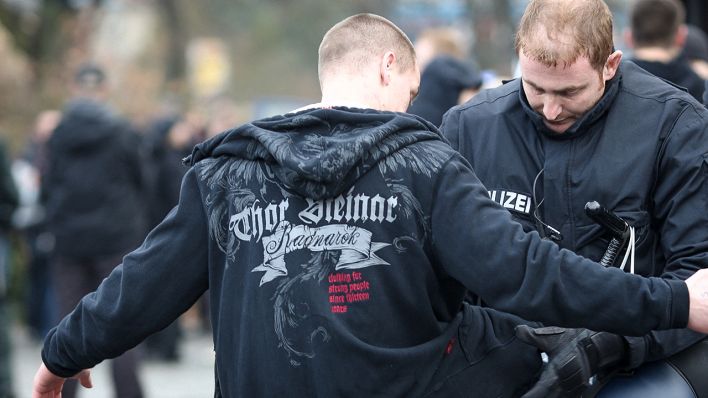 Symbolbild: Ein NPD-Anhänger wird n Berlin-Neukölln auf dem Weg zu einer Kundgebung durchsucht. (Quelle: dpa/Florian Schuh)