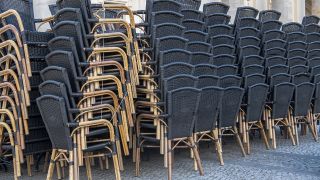 Zusammengestellte Stühle stehen vor einem gastronomischen Betrieb in Potsdam. (Quelle: dpa/Paul Zinken)