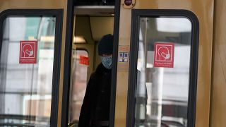 Mit Mund-Nasen-Schutz verlässt ein Mann am 10.11.2020 eine S-Bahn am Bahnhof Alexanderplatz. (Quelle: dpa/Jörg Carstensen)