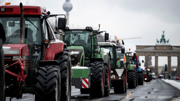 Eine Reihe Traktoren fährt die Straße des 17. Junis entlang. (Quelle: dpa/Fabian Sommer)