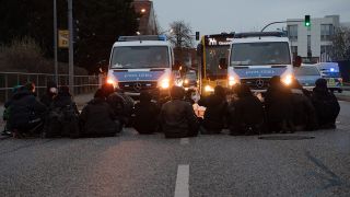 Demonstranten blockieren eine Kreuzung auf der Waßmannsdorfer Chaussee in Schönefeld