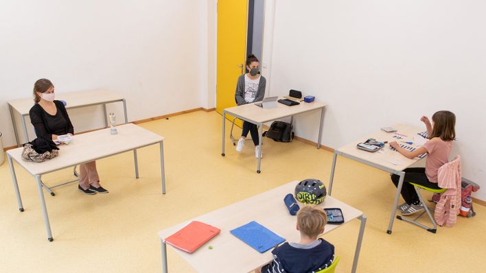 Symbolbild: Lehrerinnen betreuen SchülerInnen einer Grundschule, die in einem Raum für die Notbetreuung sitzen. (Quelle: dpa/F. Gentsch)