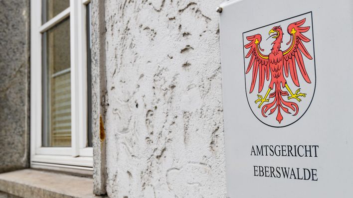Ein Schild mit der Aufschrift «Amtsgericht Eberswalde» mit dem roten Adler des Landes Brandenburg ist an der Fassade des Hauses zu sehen. (Quelle: dpa/Patrick Pleul)