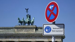 Pariser Platz, Berlin, Vor dem Brandenburger Tor mit der Quadriga steht ein Schild mit Maskenpflicht. (Quelle: dpa/Sascha Steinach)
