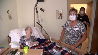 Pflegerin Erika Prinz mit FFP-2-Maske am Bett einer Pflegeheim-Bewohnerin. (Quelle: rbb)