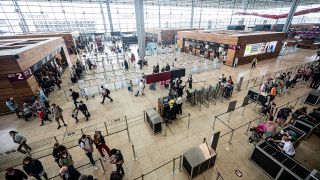 Reisende stehen am Flughafen im Terminal 1 (Quelle: DPA/Fabian Sommer)