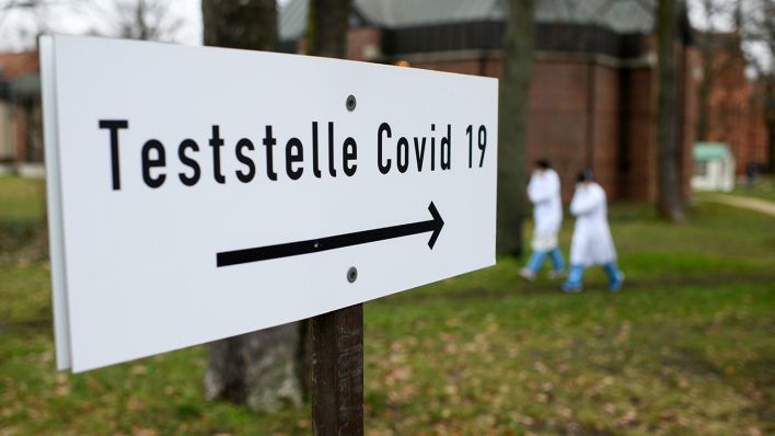Ein Schild weist auf die Coronavirus-Teststelle (Quelle: dpa/Bernd von Jutrczenka)