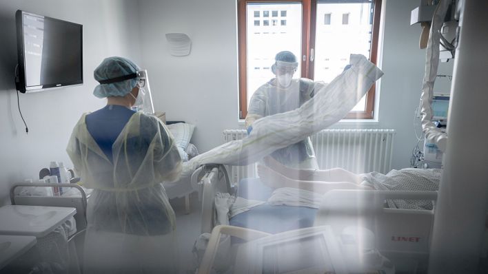 Intensivpflegerin Sandy Plückhahn (r) und Mirjana Suljagic, Röntgen-Assistentin, bereiten auf der Intensivstation des Krankenhauses Bethel Berlin eine an Covid-19 erkrankten Patientin vor (Bild: dpa/Kay Nietfeld)