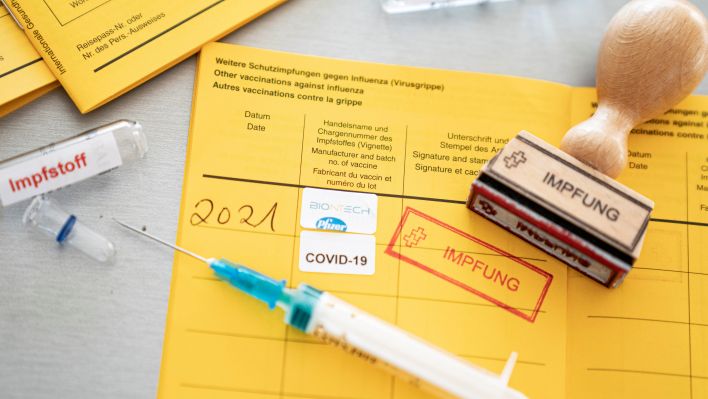 Symbolfoto: Impfung eines Covid-Impfstoffs und Dokumentation im internationalen Impfpass. (Quelle: Jens Krick/Flashpic)