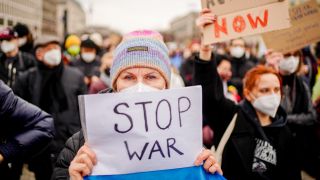 Zahlreiche Menschen demonstrieren unter anderem mit einem Plakat mit der Aufschrift «Stop war» (dt. Krieg beenden) vor dem Brandenburger Tor gegen den russischen Angriff auf die Ukraine. (Quelle: Kay Nietfekd/dpa)