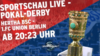 Der DFB-Pokal vor Bildern von Hertha- und Union-Fans
