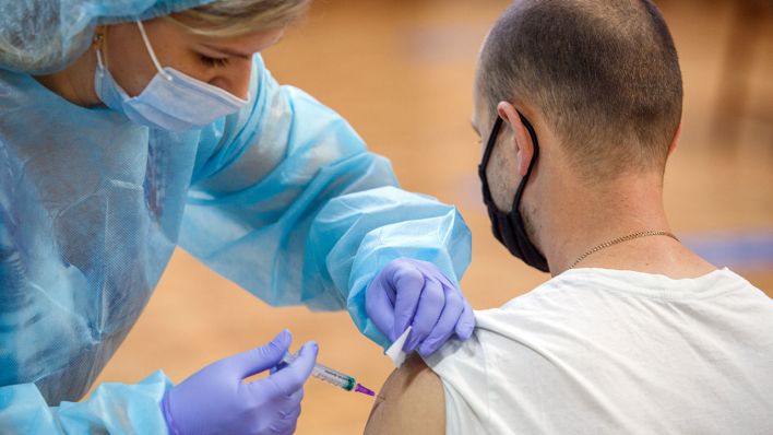 Ein Mann wird gegen Corona geimpft (Bild: dpa/Ukrinform)