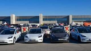 Elektrofahrzeuge der Marke Tesla stehen an Ladesäulen vor dem neuen Werk der Tesla-Fabrik Berlin Brandenburg. (Quelle: dpa/P. Pleul)