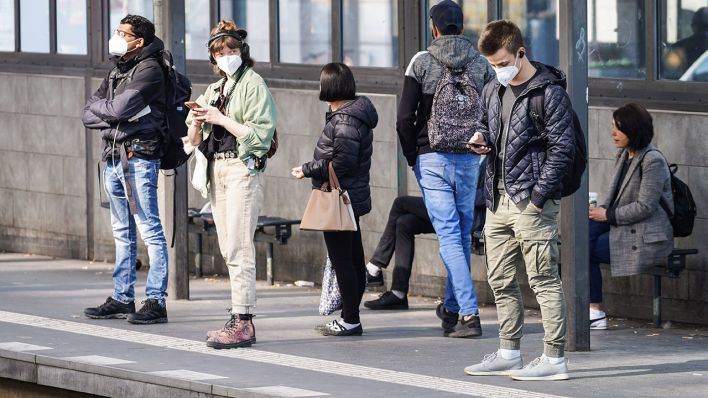 Menschen stehen mit Maske an einem Berliner S-Bahnhof (Bild: imago images/Stefan Zeitz)