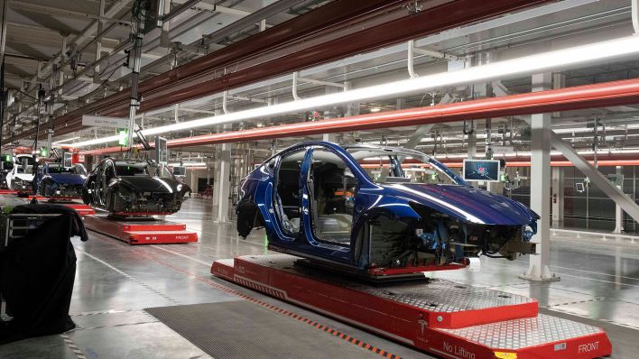 Symbolbild: Die Karosserie eines Tesla-Fahrzeugs in einer Produktionshalle. (Quelle: dpa/B. Daemmrich)