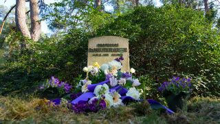 Blumen stehen an der Gedenkstätte für den Musikwissenschaftler Max Friedlaender auf dem Südwestkirchhof vor einem Stein mit der Aufschrift „Professor Dr. Max Friedlaender“. (Quelle: dpa/Soeren Stache)