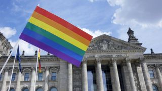 Symbolbild: Regenbogenfahne vor dem Reichstagsgebäude. (Quelle: imago images/S. Steinach)