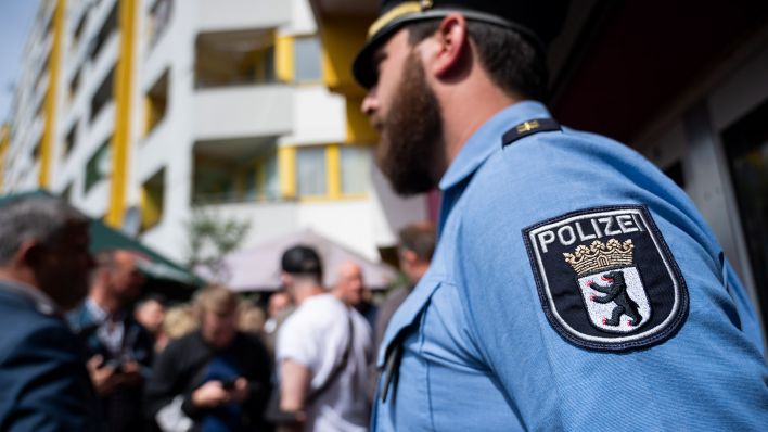 Symbolbild: Ein Polizist steht während einer Pressekonferenz am Kottbusser Tor. (Quelle: dpa/C. Gateau)