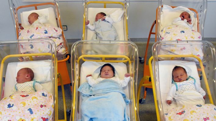 Symbolbild: Wenige Stunden alte Babys liegen in der Geburtenstation im Krankenhaus. (Quelle: dpa/W. Grubitzsch)