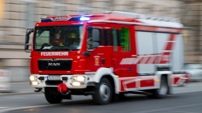 Symbolbild: Ein Feuerwehrauto mit eingeschaltetem Blaulicht fährt zum Einsatz. (Quelle: dpa/M. Skolimowska)
