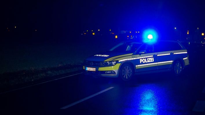 Symbolbild: Ein Einsatzfahrzeug der Polizei steht in Dunkelheit mit Blaulicht (Quelle: dpa/Gelhot)