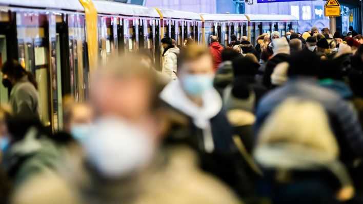 Symbolbild: Viele Menschen steigen mit Maske am Alexanderplatz in eine S-Bahn ein und aus