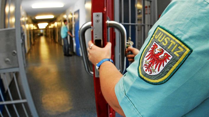 Symbolbild:Brandenburger Justizbeamtin schließt eine Tür in einer JVA auf.(Quelle:imago images/R.Weisflog)