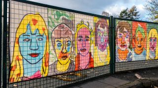 Symbolbild: Bunte Portrais hängen am Zaun einer Schule in Berlin (Quelle: dpa/Karl-Heinz Spremberg)
