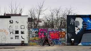 Symbolbild:Ein Mann geht an einer Lücke in der East Side Gallery in Berlin vorüber.(Quelle:dpa/S.Stache)