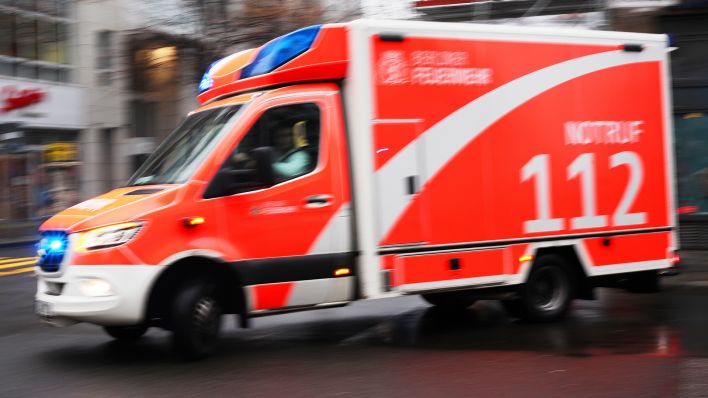 Symbolbild: n Rettungswagen der Berliner Feuerwehr fährt am 05.12.2022 bei einem Notfalleinsatz mit Blaulicht ueber eine Strasse in Mitte. (Quelle: dpa/Wolfram Steinberg)