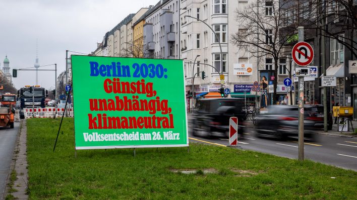 Archivbild: Ein Plakat mit der Aufschrift "Berlin 2030: Günstig, unabhängig, klimaneutral - Volksentscheid am 26. März" steht auf der Frankfurter Allee. (Quelle: dpa/C. Gateau)