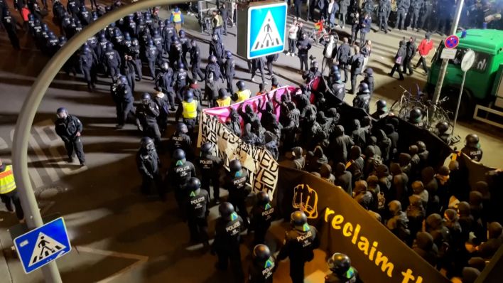 Polizeikräfte und Demonstrierende laufen an der Polizeiwache am Kottbusser Tor vorbei. (Bild: rbb/Stefan Oberwalleney)