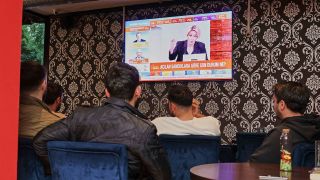Gäste des Shisha Café Deplasman in der Wollankstraße sehen sich die Berichterstattung zur Präsidenten- und Parlamentswahl in der Türkei am 14.05.2023 auf einem Fernseher an.(Quelle:dpa/J.Carstensen)