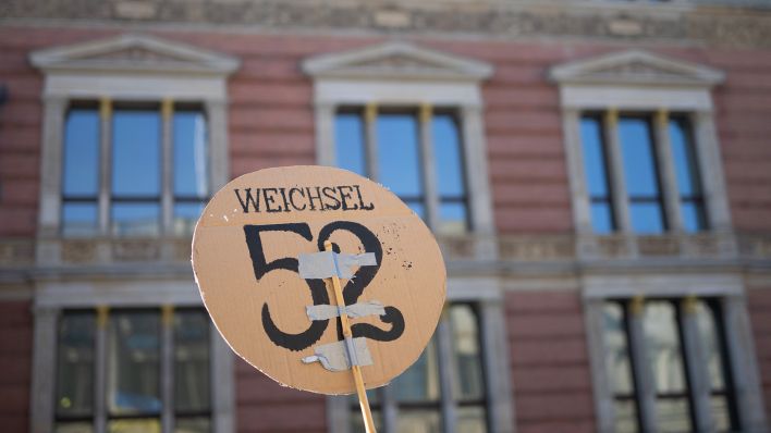 Ein Demonstrant hält am 07.09.2023 vor der 34. Plenarsitzung des Berliner Abgeordnetenhaus vor dem Gebäude während einer Kundgebung für eine Wohnungspolitik mit bezahlbaren Mieten ein Schild mit der Aufschrift «Weichsel 52» hoch. (Quelle: dpa/Sebastian Christoph Gollnow)