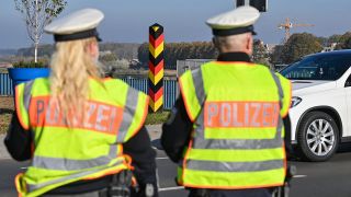 Eine Beamtin und ein Beamter der Bundespolizei stehen am deutsch-polnischen Grenzübergang Stadtbrücke in Frankfurt (Oder) und überwachen den Einreiseverkehr. (Quelle: dpa/Patrick Pleul)