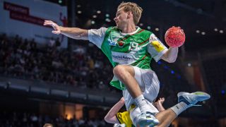 Füchse-Star Mathias Gidsel springt und holt zum Wurf aus. (Quelle: IMAGO/Beautiful Sports)
