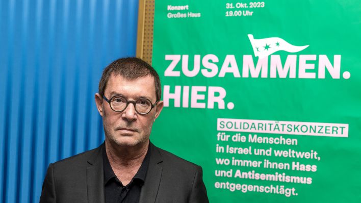 Archivbild:Der Intendant des Staatstheaters Cottbus, Stephan Märki, steht am 25.10.2023 vor einem Plakat, auf dem zu einem Solidaritätskonzert eingeladen wird.(Quelle:dpa/F.Hammerschmidt)
