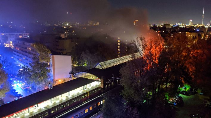 Ein Sonderzug eines privaten Bahnunternehmens (vorn) steht brennend im S-Bahnhof Bellevue. (Quelle: dpa)