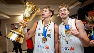 Die Brüder Franz und Moritz Wagner posieren mit dem Weltmeister-Pokal nach der Basketball-WM (Quelle: imago images/camera4+)