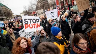 Eine Person demonstrieren nach dem Tod des Regimekritikers Nawalny gegen die russische Regierung mit einem Schild mit der Aufschrift "stop Putin" in Berlin-Mitte. (Quelle: dpa/Sommer)