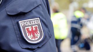 Ein Wappen der Polizei Brandenburg auf einer Uniform. (Quelle: imago-images/Sebastian Grabsch)