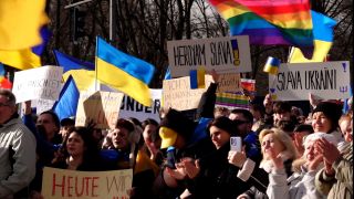 Menschenmasse demonstriert für die Ukraine mit Flaggen und Schildern.