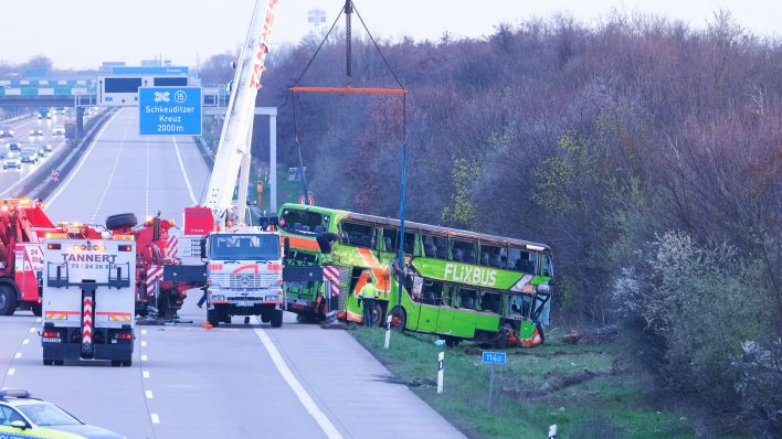 27.03.2024, Sachsen, Schkeuditz: Ein verunglückter Reisebus wird an der Unfallstelle auf der A9 von einem Kran geborgen. (Quelle: dpa/Sebastian Willnow)